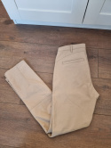 Beige cotton trousers with buttons on the calves